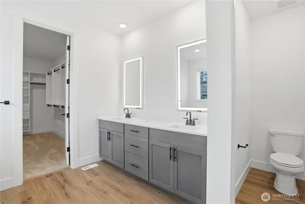 a bathroom with a white tub shower and vanity