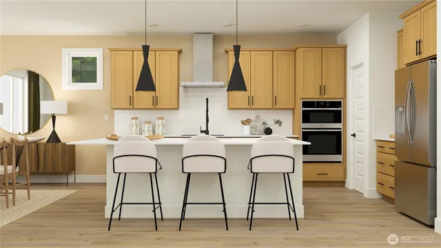 a kitchen with stainless steel appliances a table chairs and a refrigerator
