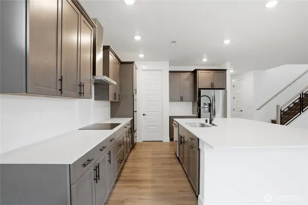 a kitchen with stainless steel appliances a sink stove and refrigerator
