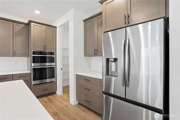 a kitchen with stainless steel appliances a refrigerator and cabinets