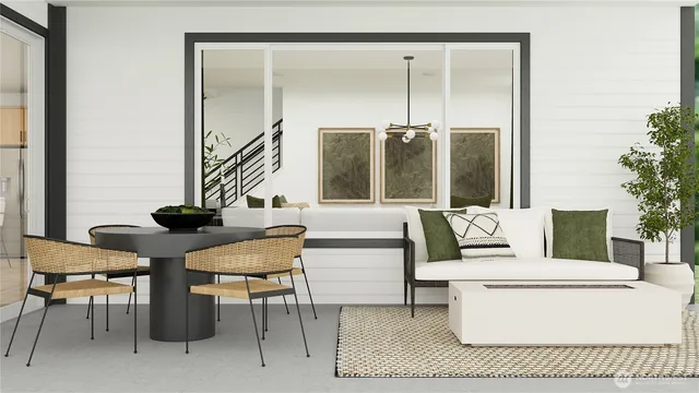 a living room with a couch and a potted plant