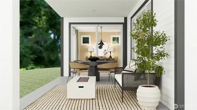 a balcony view with a potted plant and outdoor seating