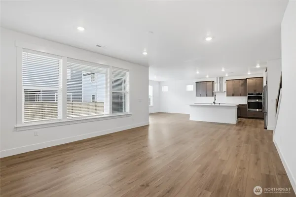 a view of kitchen with wooden floor and windows