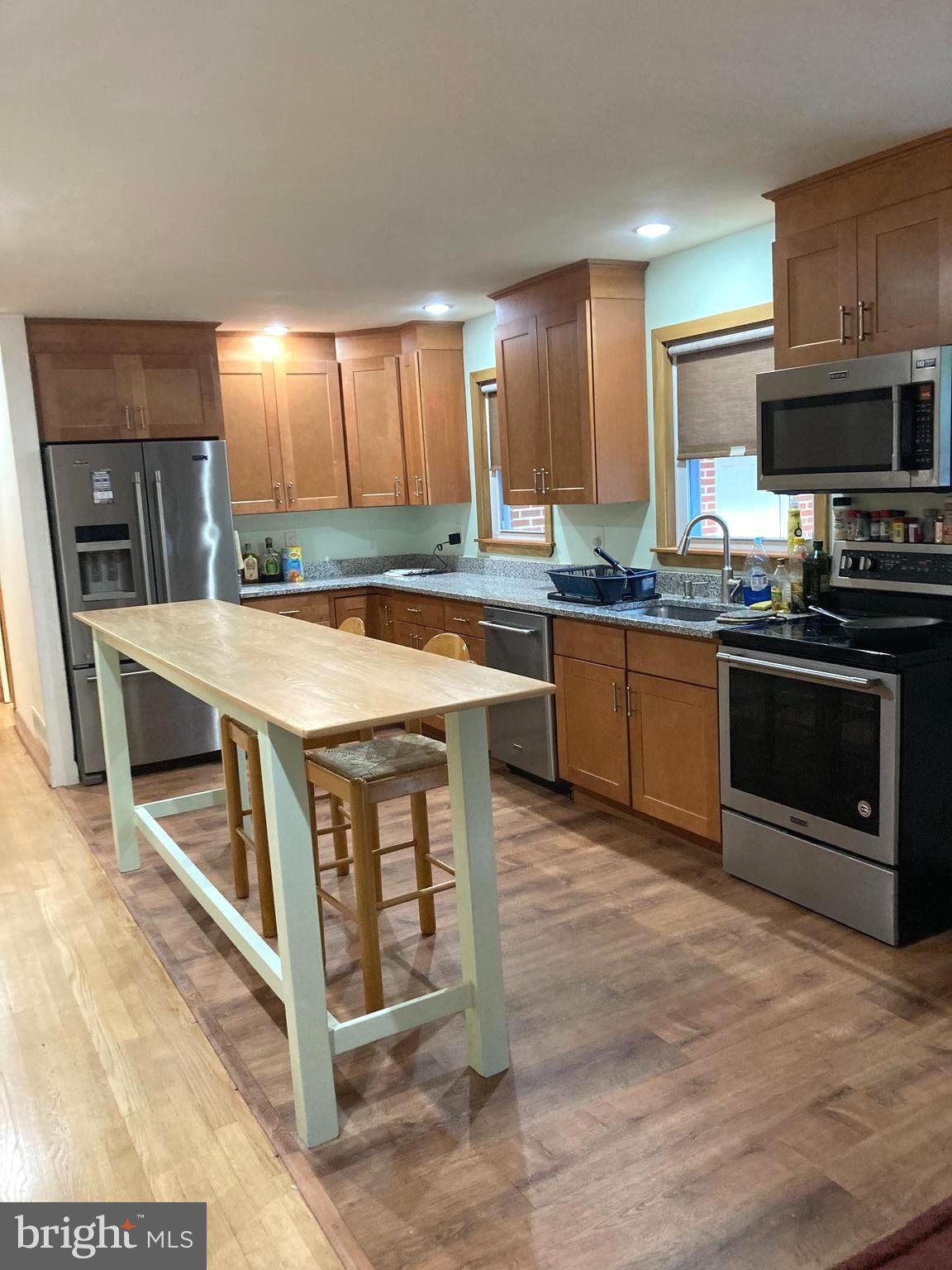 1713 Cape May Road Baltimore, MD 21221 - Photo 12 of 34 a kitchen with stainless steel appliances granite countertop a stove top oven a sink dishwasher and a refrigerator