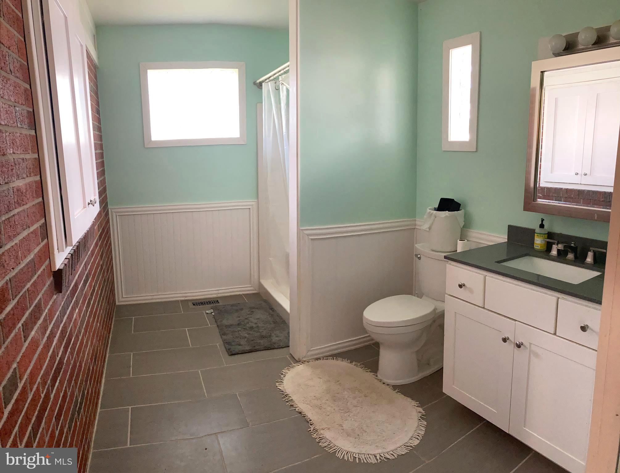 1713 Cape May Road Baltimore, MD 21221 - Photo 17 of 34 a bathroom with a toilet a sink and window
