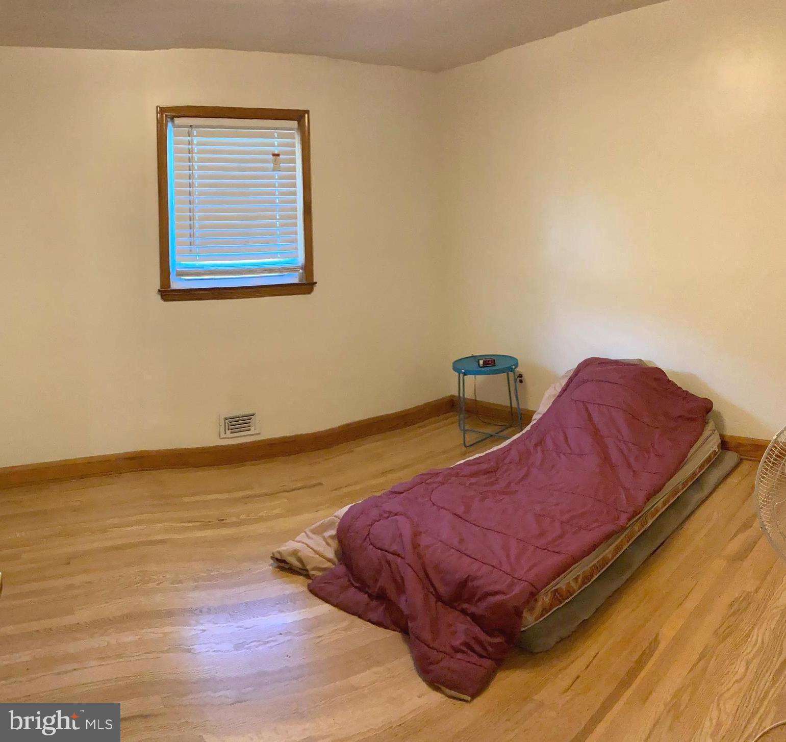 1713 Cape May Road Baltimore, MD 21221 - Photo 20 of 34 a bed sitting in a bedroom next to a window