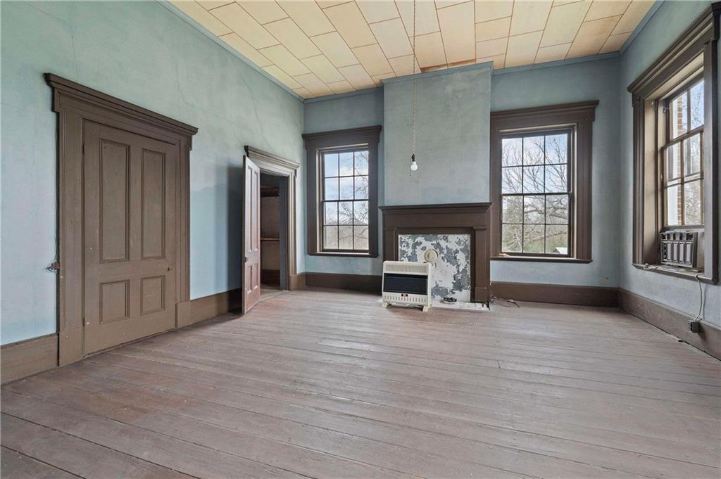 12871 Linton Road Sparta, GA 31087 - Photo 22 of 56 an empty room with furniture and fireplace