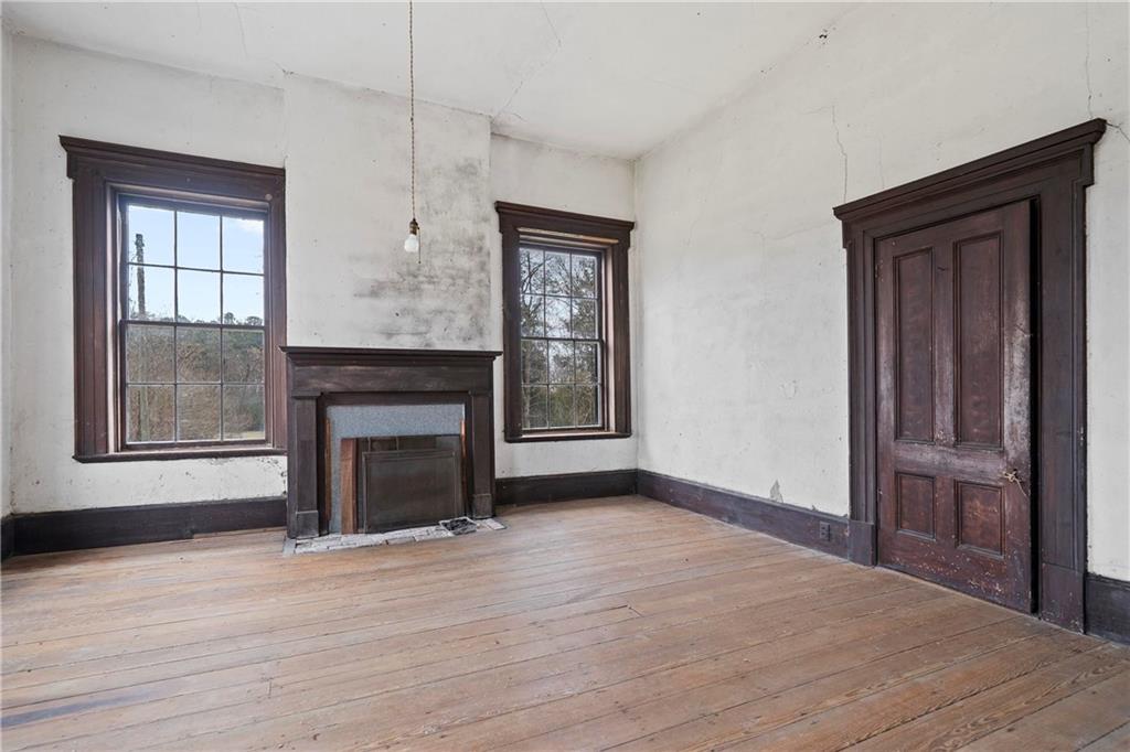 12871 Linton Road Sparta, GA 31087 - Photo 25 of 56 a view of an empty room with window and fire place