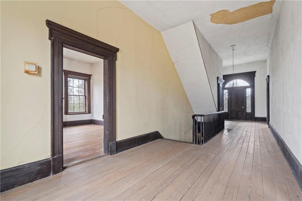 12871 Linton Road Sparta, GA 31087 - Photo 26 of 56 a view of a hallway view with wooden floor and staircase