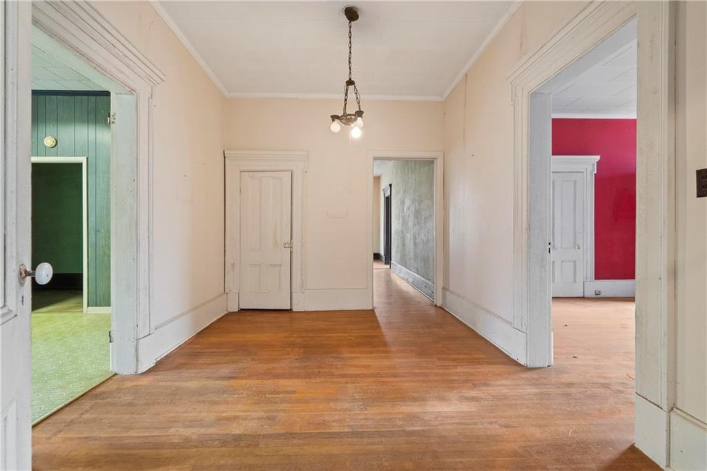 12871 Linton Road Sparta, GA 31087 - Photo 37 of 56 a view of a hallway with wooden floor and staircase