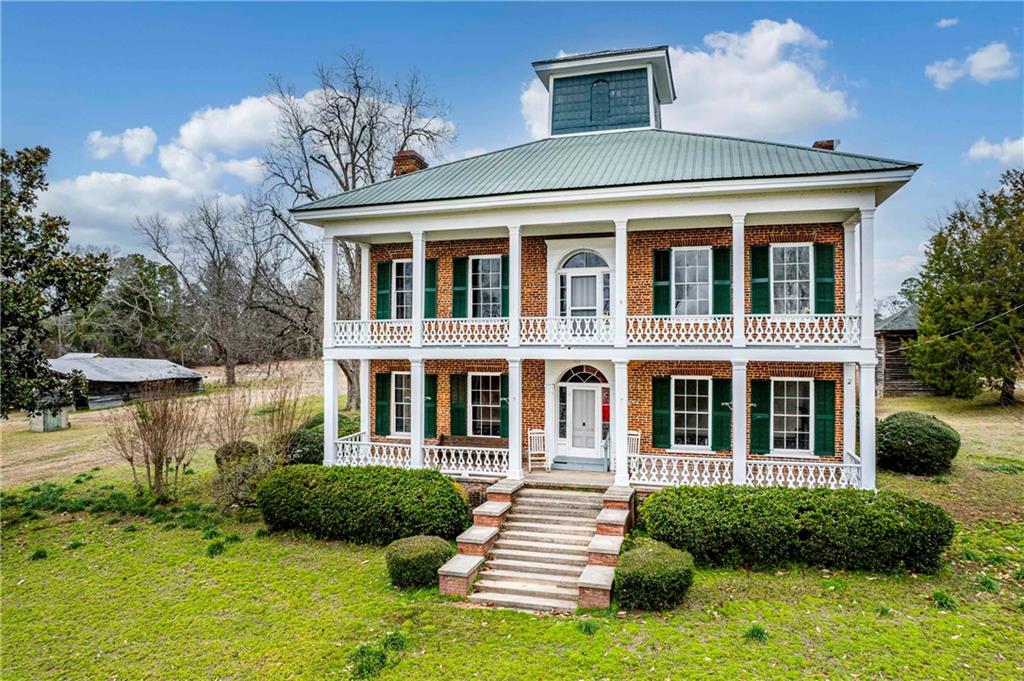 12871 Linton Road Sparta, GA 31087 - Photo 4 of 56 a front view of a house with a yard