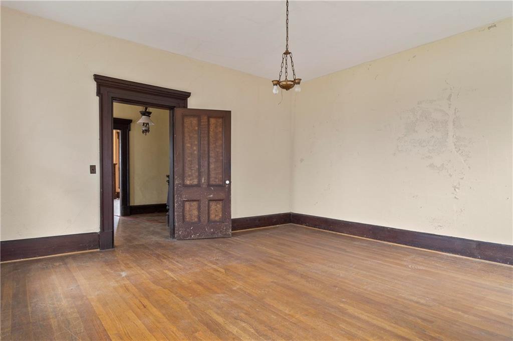12871 Linton Road Sparta, GA 31087 - Photo 44 of 56 a view of empty room with wooden floor and ceiling fan