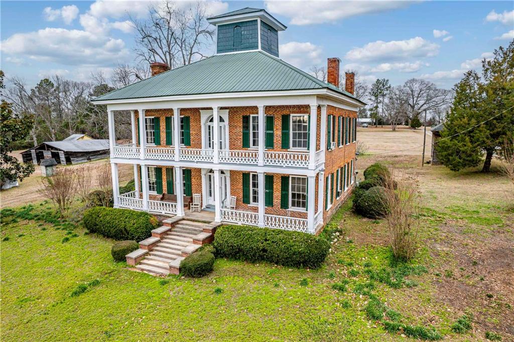 12871 Linton Road Sparta, GA 31087 - Photo 6 of 56 a front view of a house with yard and green space