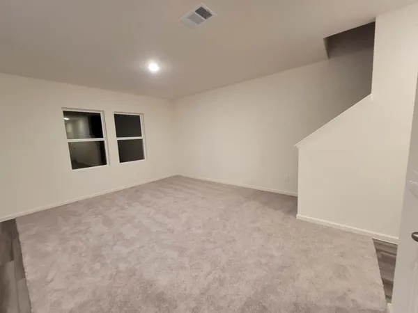 a view of an empty room with windows