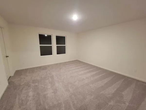 an empty room with a empty space and windows