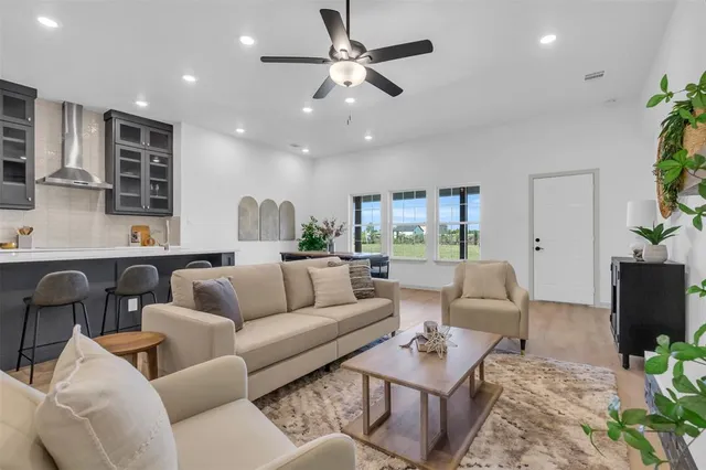 a living room with furniture and a wooden floor