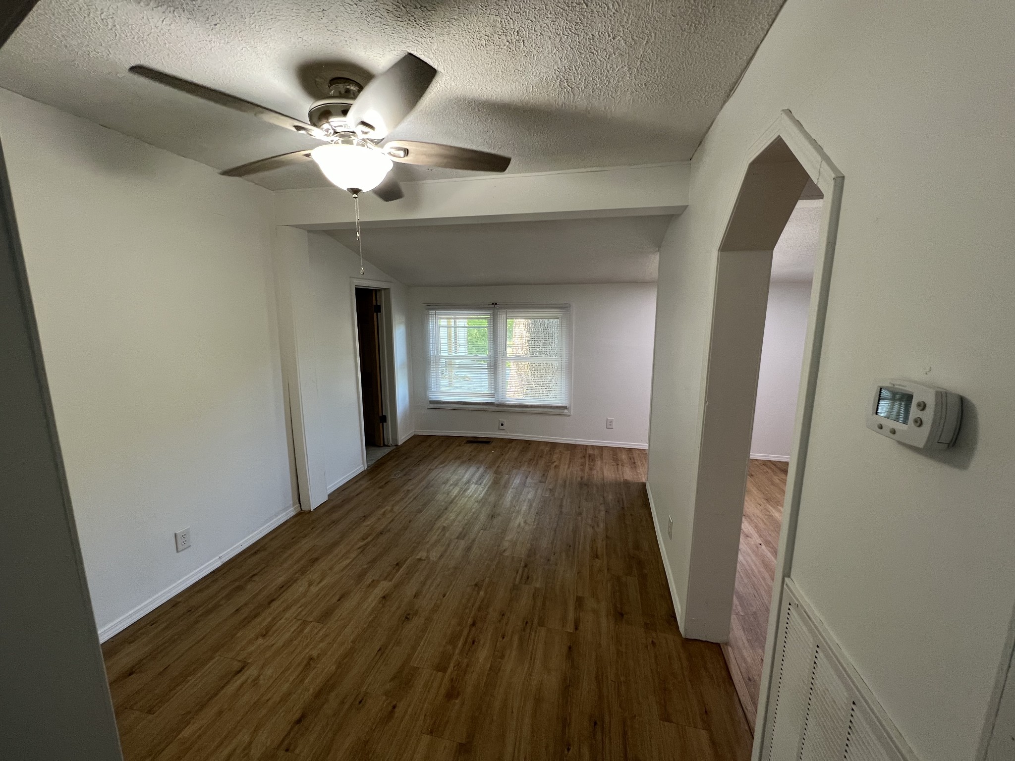 507 Spring Street East Cookeville, TN 38501 - Photo 2 of 15 a view of an empty room with wooden floor and a window