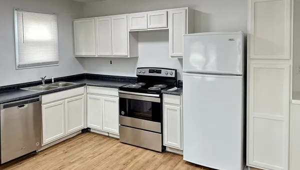 a white refrigerator freezer sitting inside of a kitchen