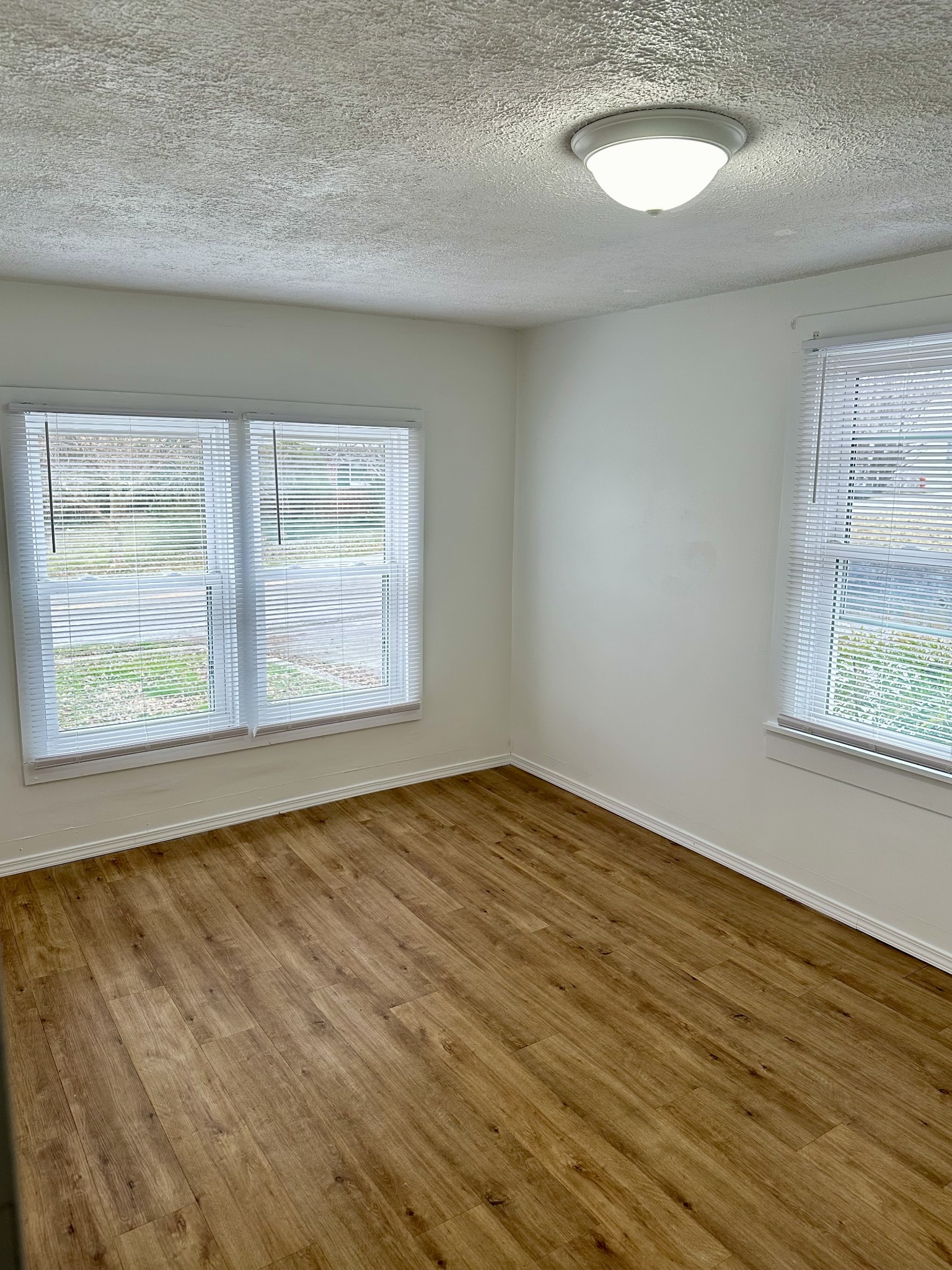 507 Spring Street East Cookeville, TN 38501 - Photo 4 of 15 a view of an empty room with wooden floor and a window