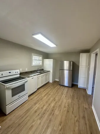 a kitchen with granite countertop a refrigerator and a stove