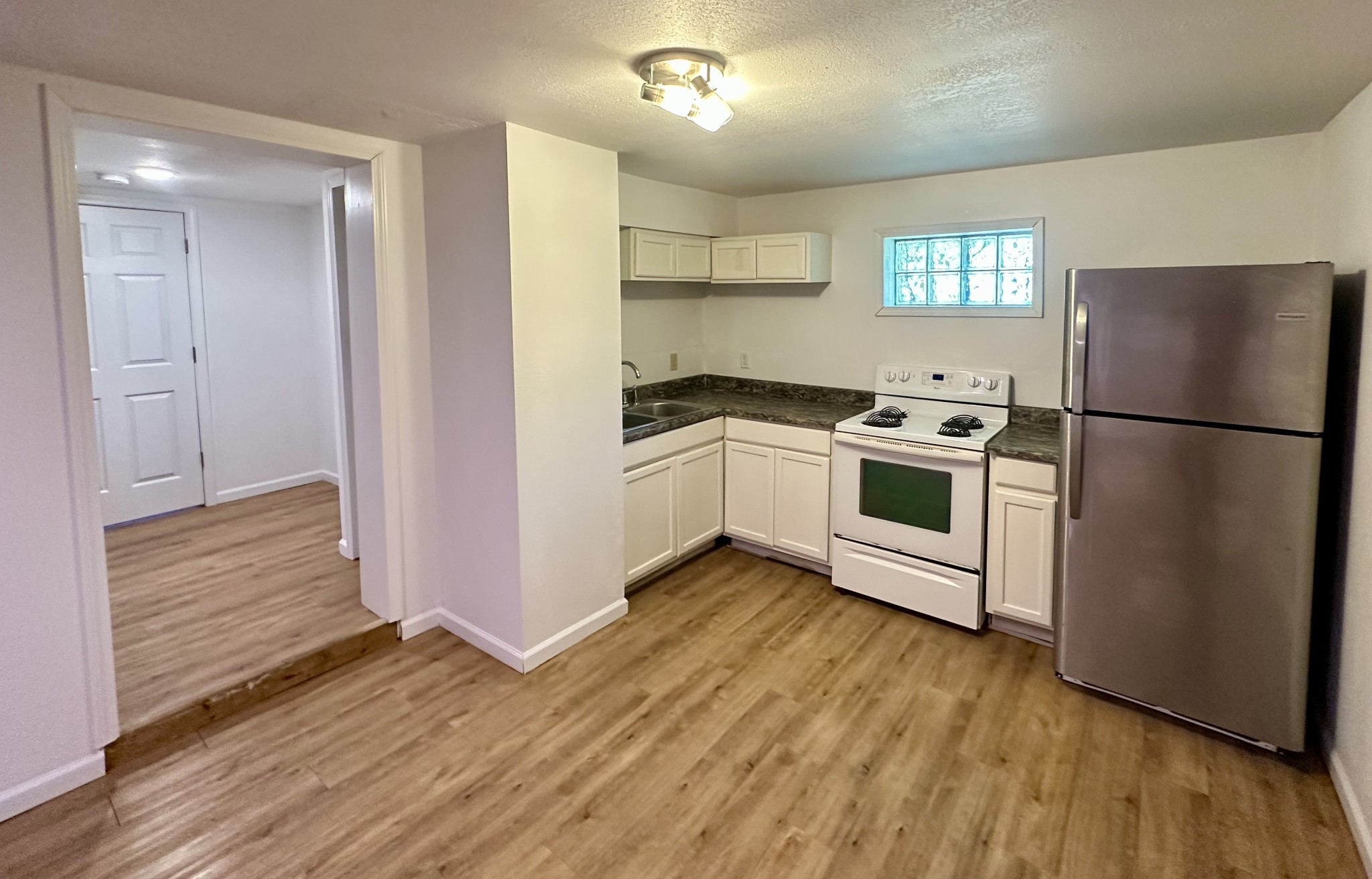 507 Spring Street East Cookeville, TN 38501 - Photo 9 of 15 a kitchen with wooden floors and appliances