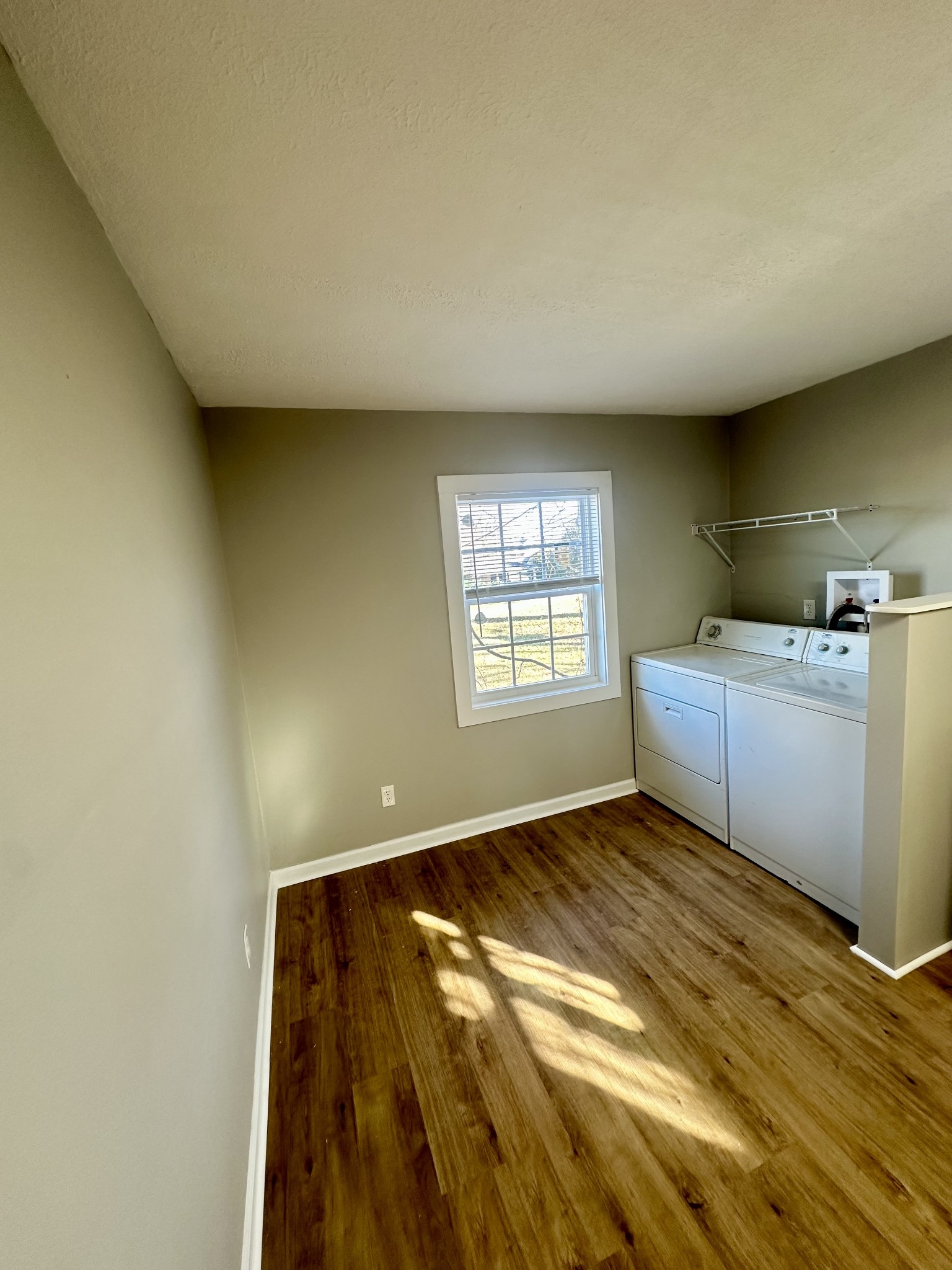 507 Spring Street East Cookeville, TN 38501 - Photo 10 of 15 a view of an empty room with a window and wooden floor