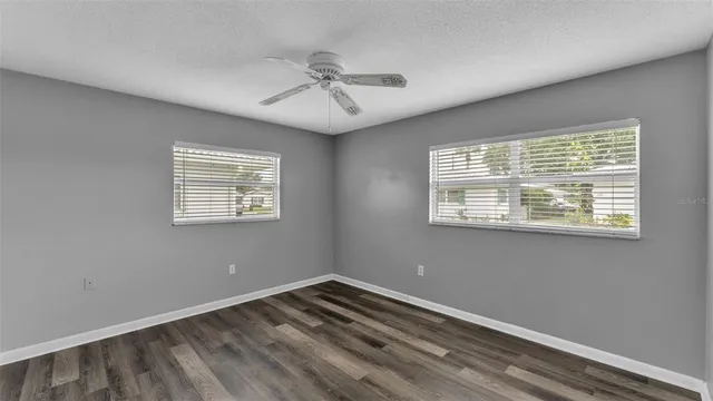 a view of empty room with wooden floor
