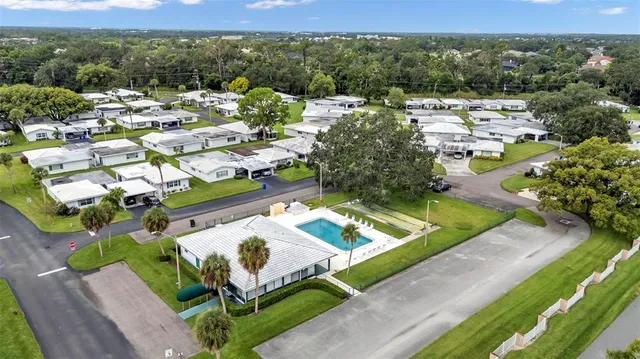 a view of a swimming pool with a patio and a garden