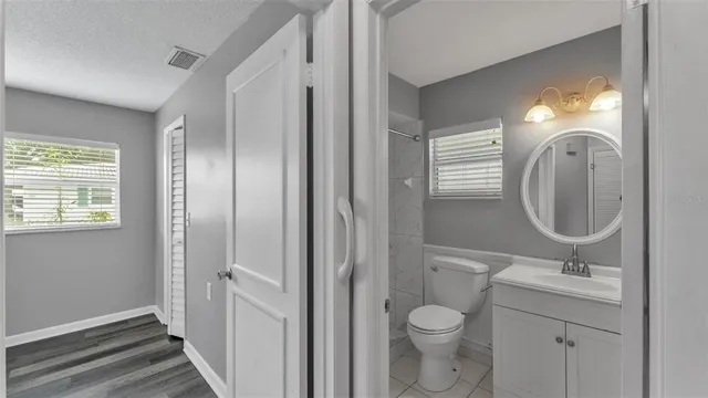 a bathroom with a toilet sink and mirror