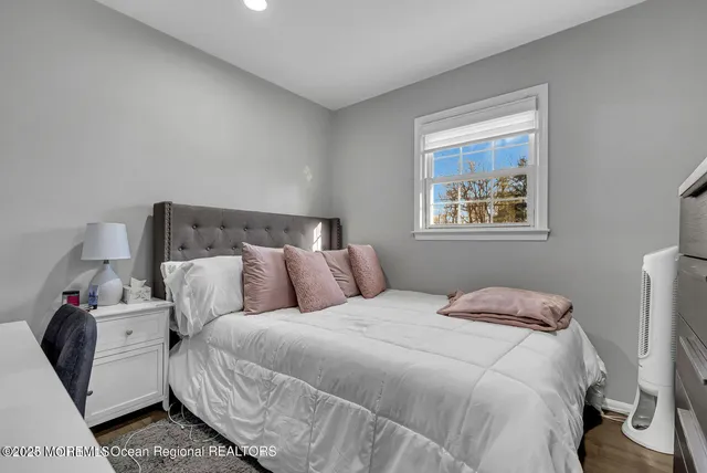 a bed room with a bed and a night stand