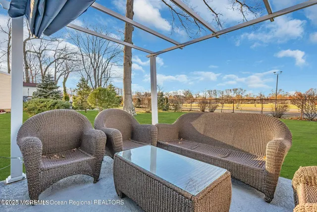a outdoor living room with furniture and a floor to ceiling window