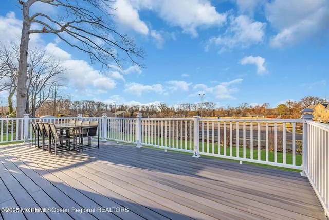 a view of a roof deck with wooden floor and fence
