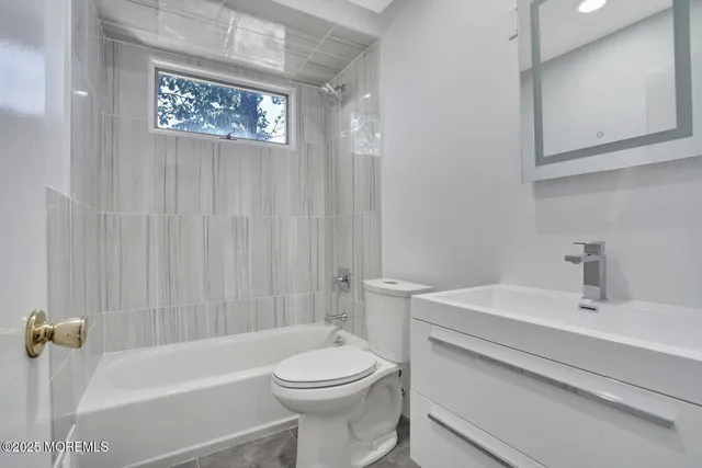 a bathroom with a sink a toilet and a bathtub