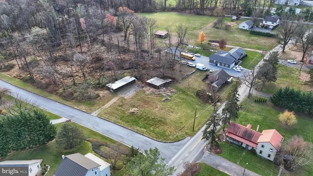 a aerial view of a house with a yard and lake view