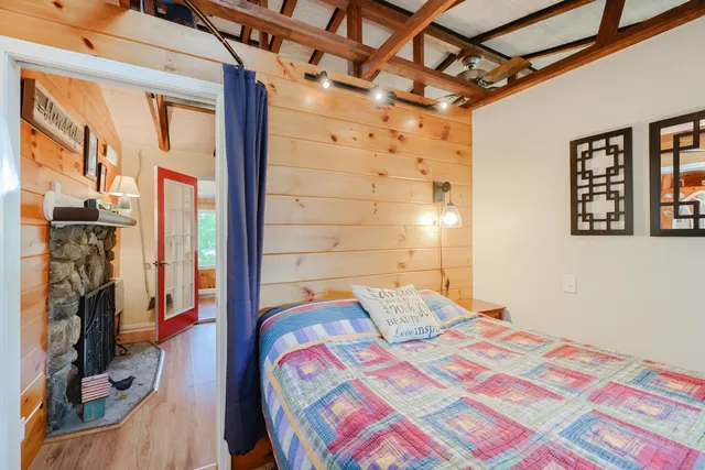 a bedroom with a bed next to a window