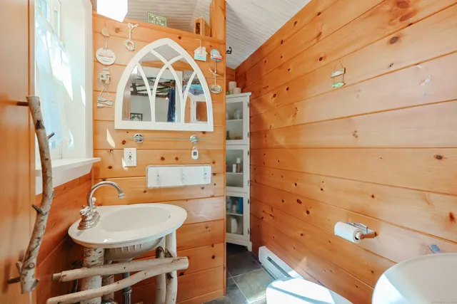 a bathroom with a sink mirror vanity and a toilet
