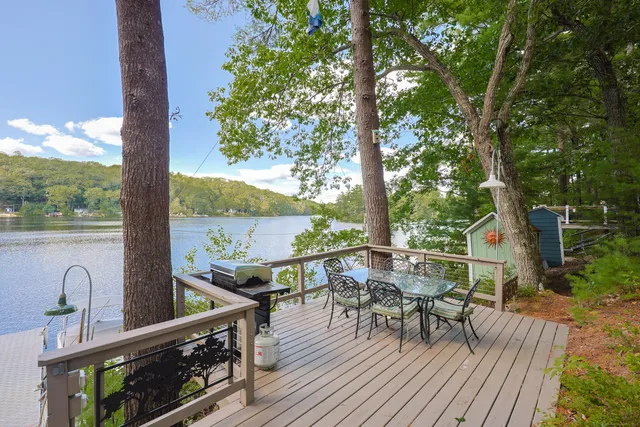 a view of a chairs and table on the wooden deck