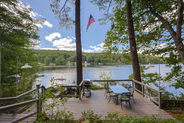a view of a lake with a bench in patio