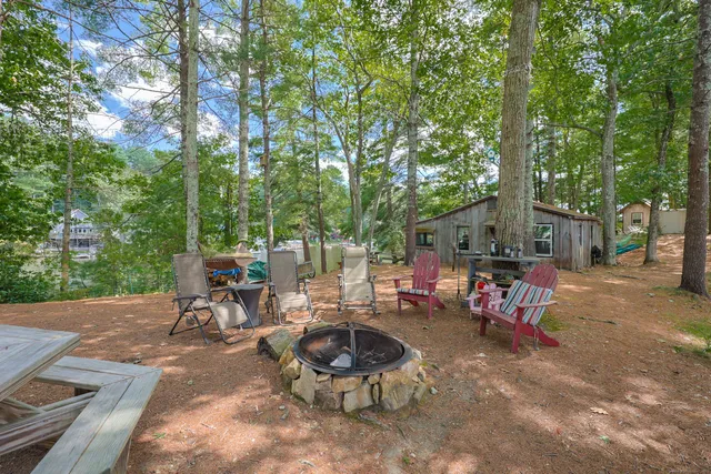 a view of a backyard with a table and chairs and a small yard