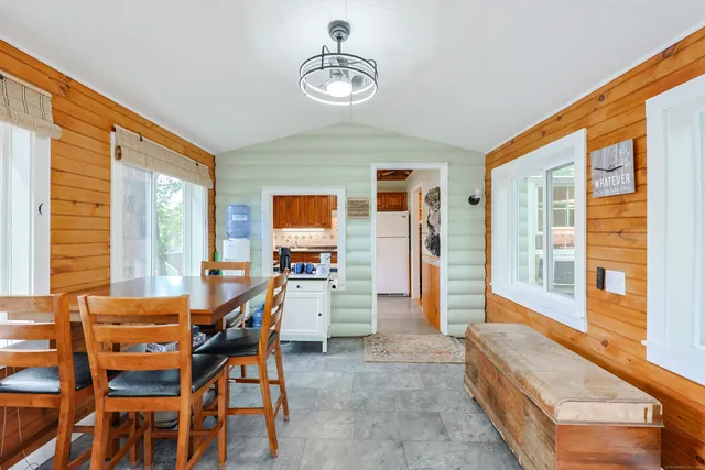 a dining room with furniture and window
