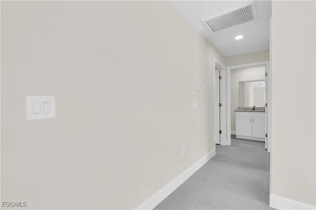 an empty room with a ceiling fan and entryway