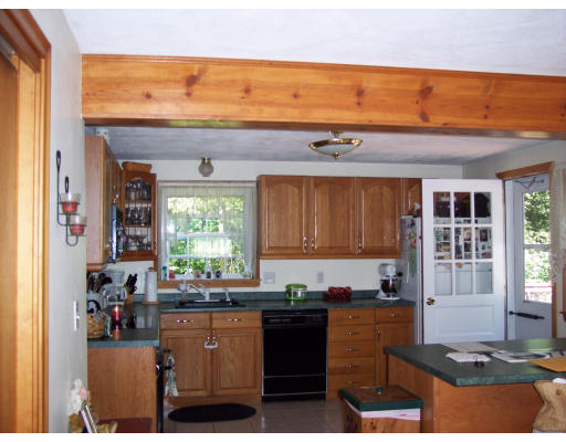 304 Salem Road Billerica, MA 01821 - Photo 3 of 5 a kitchen with granite countertop a stove cabinets and a counter top space