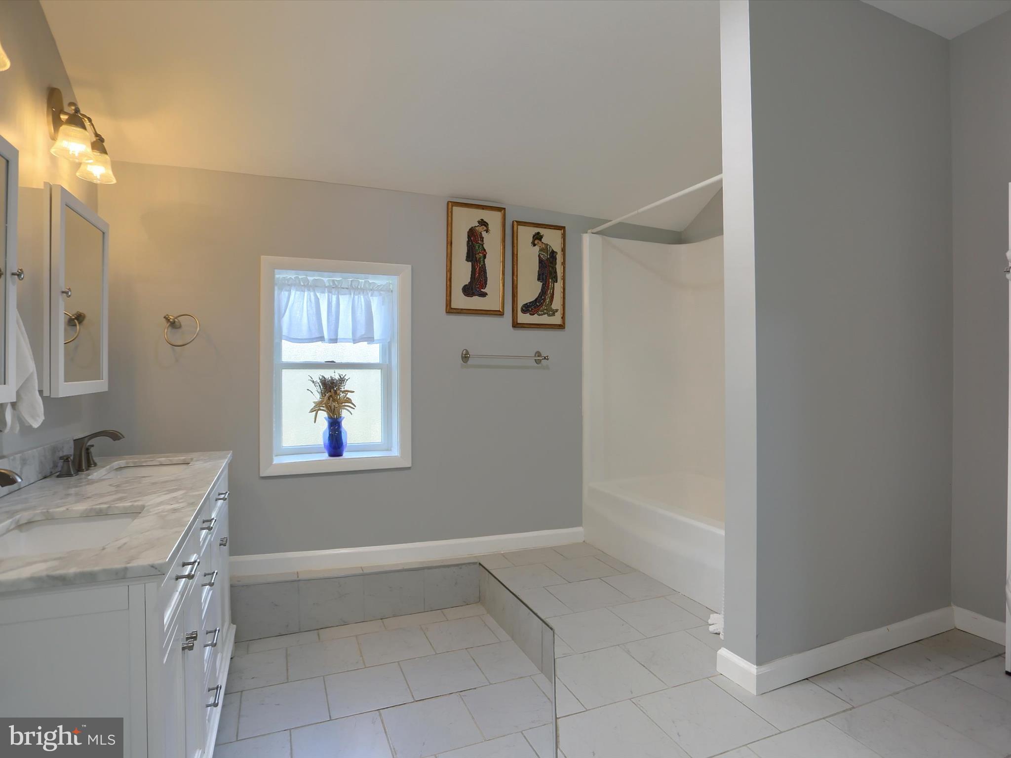 5931 York Road Spring Grove, PA 17362 - Photo 20 of 38 a bathroom with a granite countertop sink a mirror and a bathtub