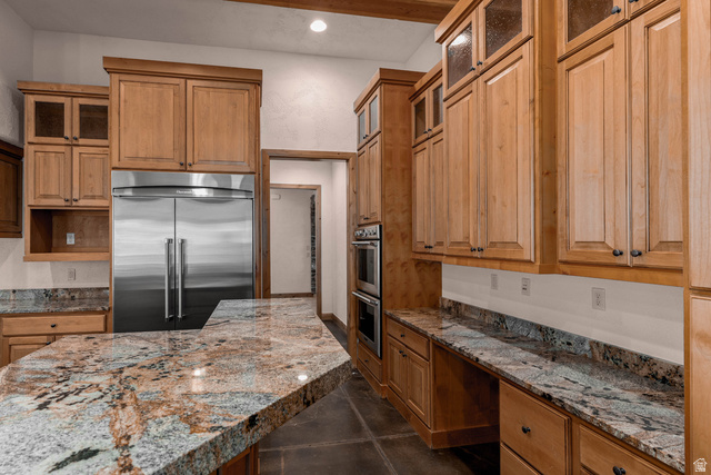 2464 East Granite Way St. George, UT 84790 - Photo 48 of 106 Kitchen featuring glass insert cabinets, stainless steel appliances, light stone counters, recessed lighting, and built in desk