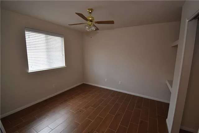 a view of a room with wooden floor and a window