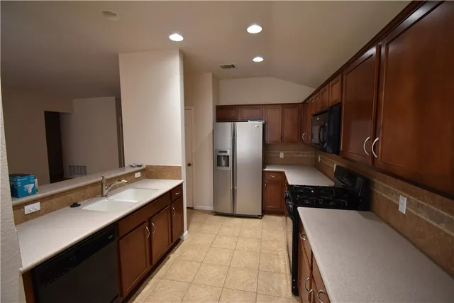 a kitchen with a refrigerator and a sink