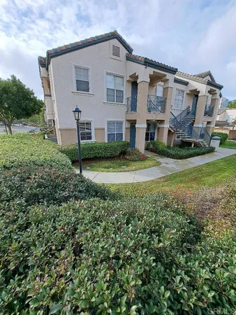 a view of a house with a big yard and large trees