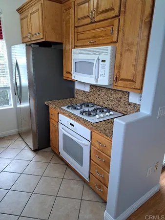 a kitchen with stainless steel appliances granite countertop a stove and a microwave