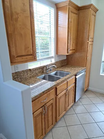 a kitchen with a sink stove and cabinets