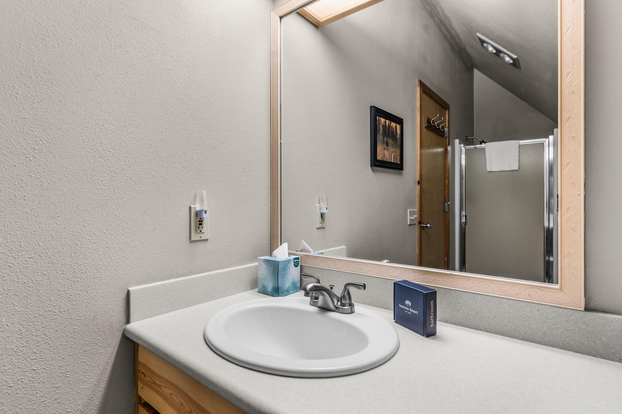 57505 Circle 4 Cabin Road, Unit 29 Sunriver, OR 97707 - Photo 24 of 35 a bathroom with a sink and a mirror